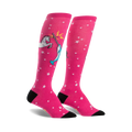 Pair of pink knee-high socks with white stars and a whimsical illustration of a unicorn fighting a narwhal.
