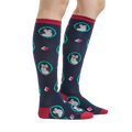 Lifestyle shot showing the Wise Owl knee-high socks on a person's legs.