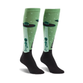 Pair of pastel green knee-high socks with aliens and UFOs. Black cuff. Fun, quirky design.