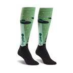 Pair of pastel green knee-high socks with aliens and UFOs. Black cuff. Fun, quirky design.
