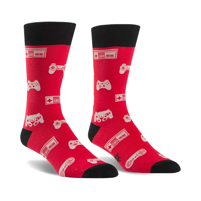 mens red crew socks with black toe, heel, and cuff featuring a repeating pattern of video game controllers and consoles.    }}