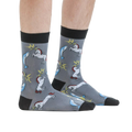 Lifestyle shot: A person modeling the Unicorn vs. Narwhal socks, showing how they look when worn.