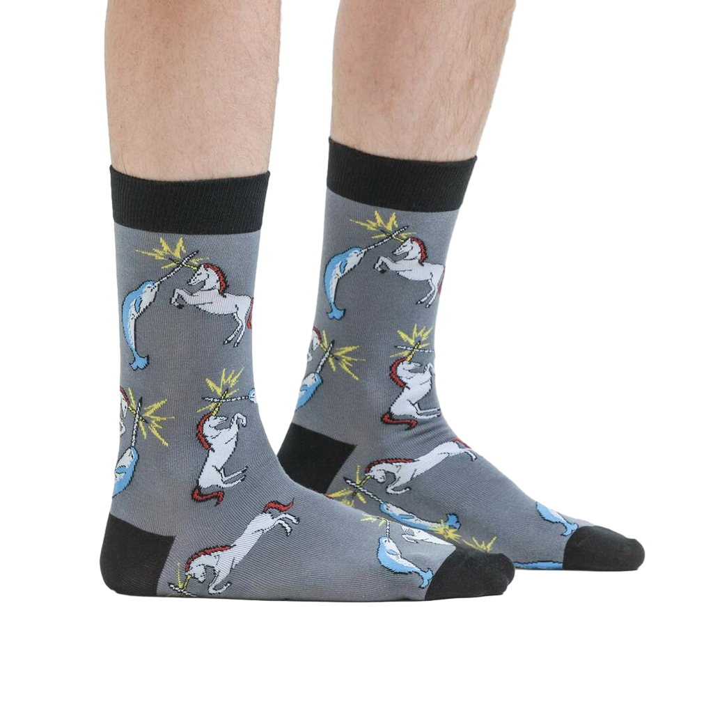 Lifestyle shot: A person modeling the Unicorn vs. Narwhal socks, showing how they look when worn.
