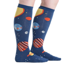 Lifestyle shot showing the Planets socks on a person's legs against a white background, from a slightly different angle.