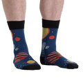 Lifestyle shot of a person wearing the Planets Socks, showcasing the design on their legs from another angle.