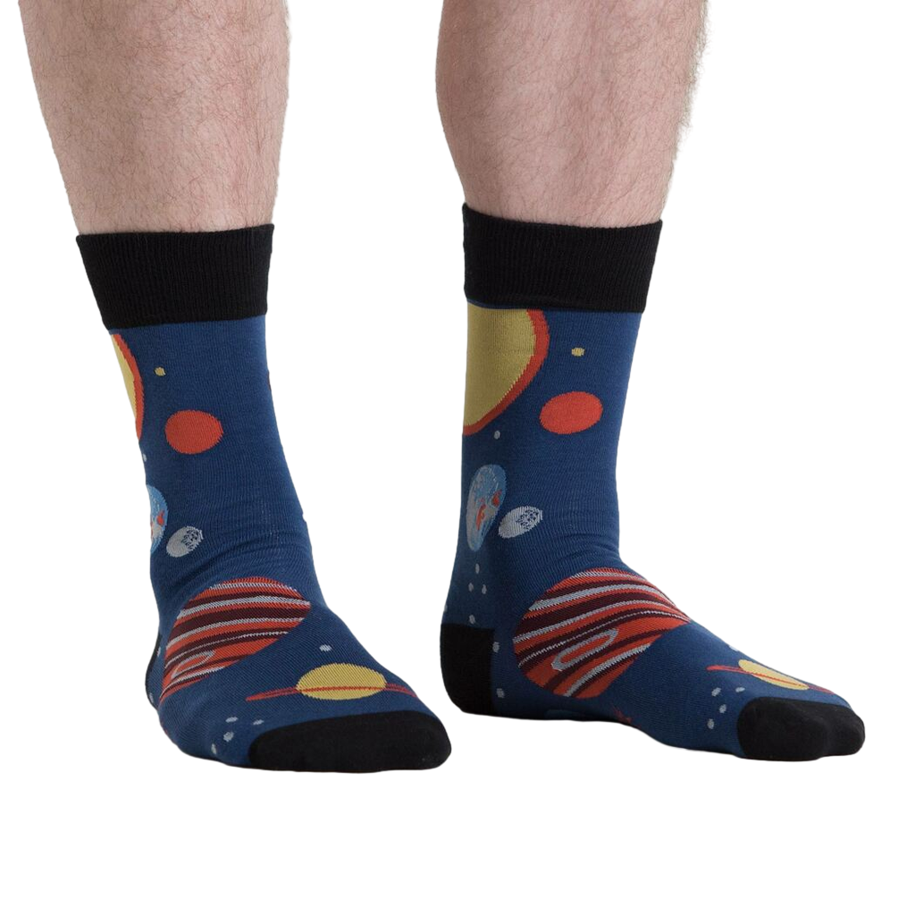 Lifestyle shot of a person wearing the Planets Socks, showcasing the design on their legs from another angle.
