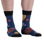 Lifestyle shot of a person wearing the Planets Socks, showcasing the design on their legs from another angle.