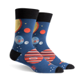 Pair of crew socks, navy blue with colorful planets, stars, and black cuffs. Fun space-themed design.