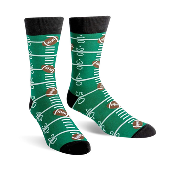 green football field crew socks with white yard markers and brown footballs for men.  