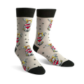 A pair of beige crew socks with a repeating pattern of red hearts, anchors, wings, and stars. Black cuffs. 'I Love Dad' is written on the heart.