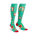 Pair of teal knee-high socks with red and gold accents. Festive designs in gold frames include a Christmas tree, Santa, reindeer and a dog.