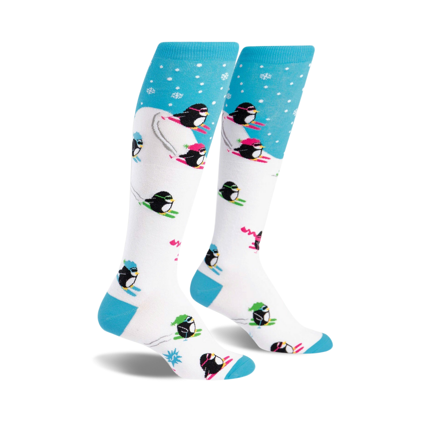 A pair of white knee-high socks with a playful design.  Blue accents at the top and bottom. Penguins skiing in neon pink, green, and black are featured on a white background with light blue snowflake accents at the top.