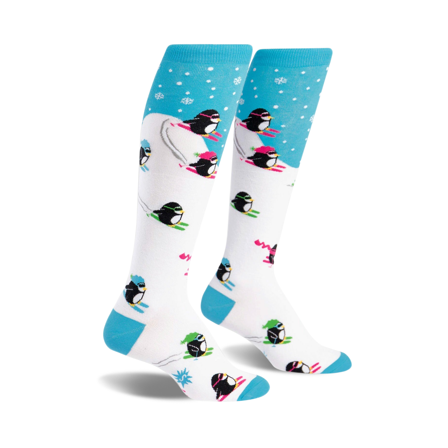 A pair of white knee-high socks with a playful design.  Blue accents at the top and bottom. Penguins skiing in neon pink, green, and black are featured on a white background with light blue snowflake accents at the top.