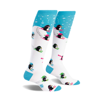 white knee-high socks with a pattern of skiing penguins on a blue background with snowflakes.   