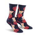 A pair of crew socks in navy blue with a playful pattern of orange kittens batting at red yarn balls.