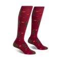 Pair of maroon knee-high socks. Features brown Bigfoot figures exchanging red hearts. Cute and quirky Valentine's Day design.