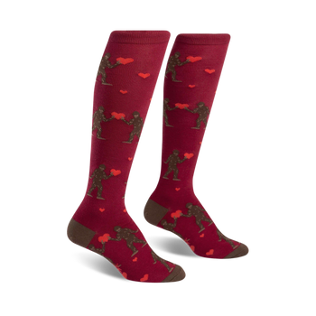 knee-high red socks with brown sasquatch holding red heart pattern.   