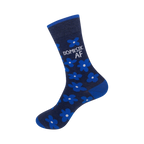 Close-up view of a navy blue crew sock showcasing the bright blue flower pattern and 'DOMESTIC AF' text.