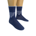 Lifestyle shot: Two pairs of navy blue socks with the witty message are modeled on feet.
