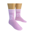 Lifestyle shot showing a person wearing a pair of lavender 'Not My Problem' crew socks.