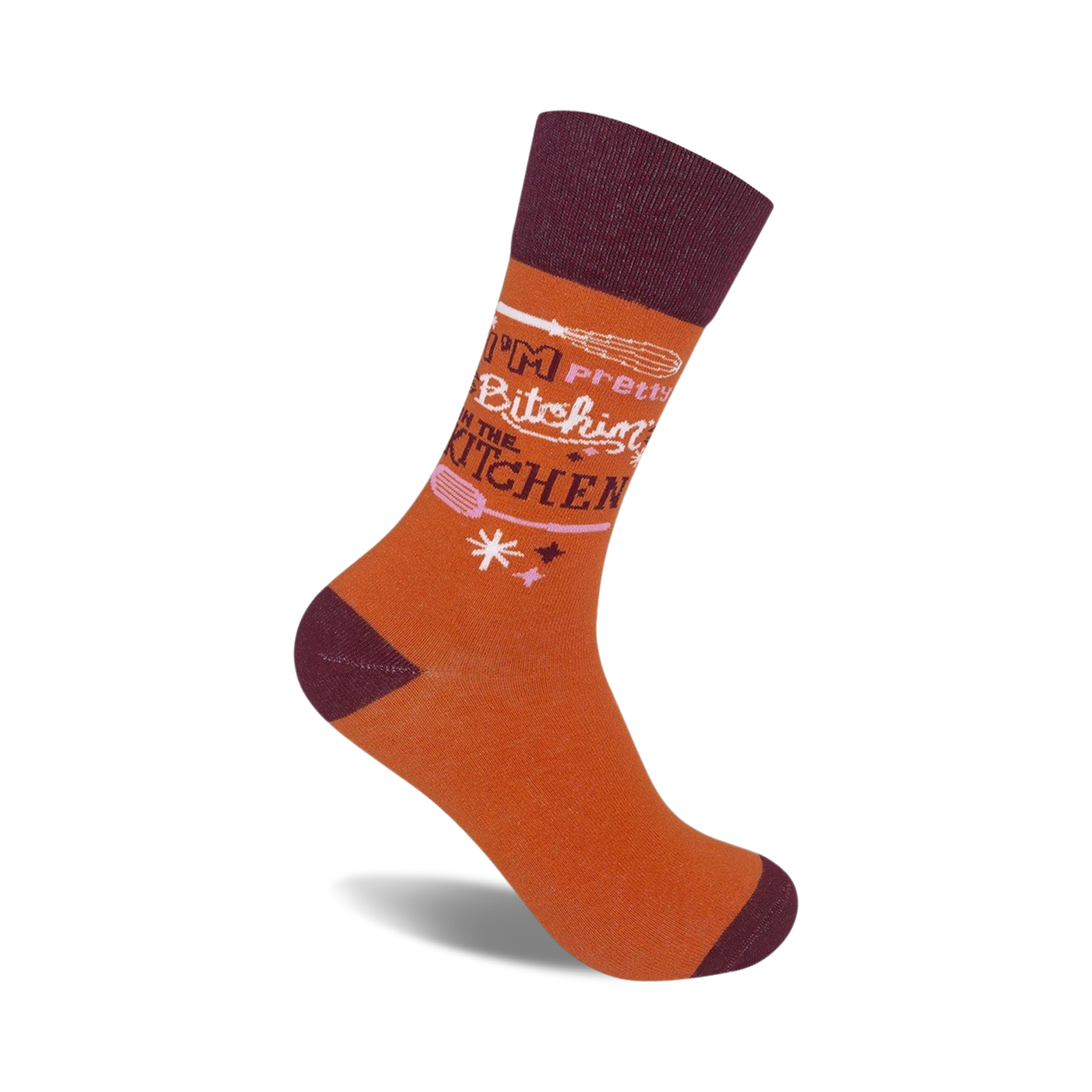 Crew socks in burnt orange and maroon. The design features the text 'I'm Pretty Bitchin' in the Kitchen' with a whisk graphic.