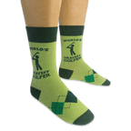 Person wearing a pair of light green World's Okayest Golfer socks on a black background, showing the side text and argyle.