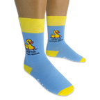 Person wearing light blue crew socks with yellow accents on a black background, showing the pixel rubber duck and text design.