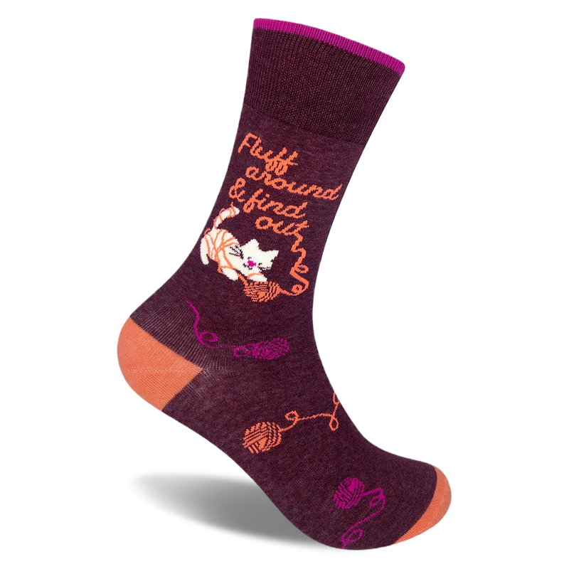 Dark burgundy crew sock with an orange heel and toe. Features a white cat tangled in yarn and text Fluff around & find out.