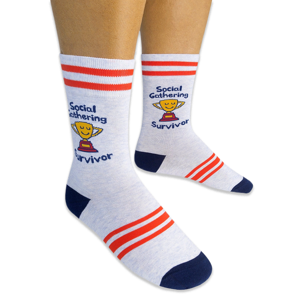 Person wearing light grey crew socks featuring red stripes, blue heels, and a yellow trophy reading Social Gathering Survivor.