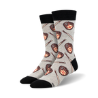 A pair of grey crew socks with a pattern of brown baseball gloves and bats.  The socks have black cuffs.