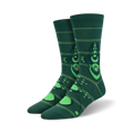 Pair of crew socks in dark green with bright green crop circle designs.  The circles have concentric rings and are connected by thin lines.