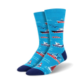 A pair of blue crew socks with illustrated red and white boats, seagulls, and buoys on a wavy ocean pattern. 