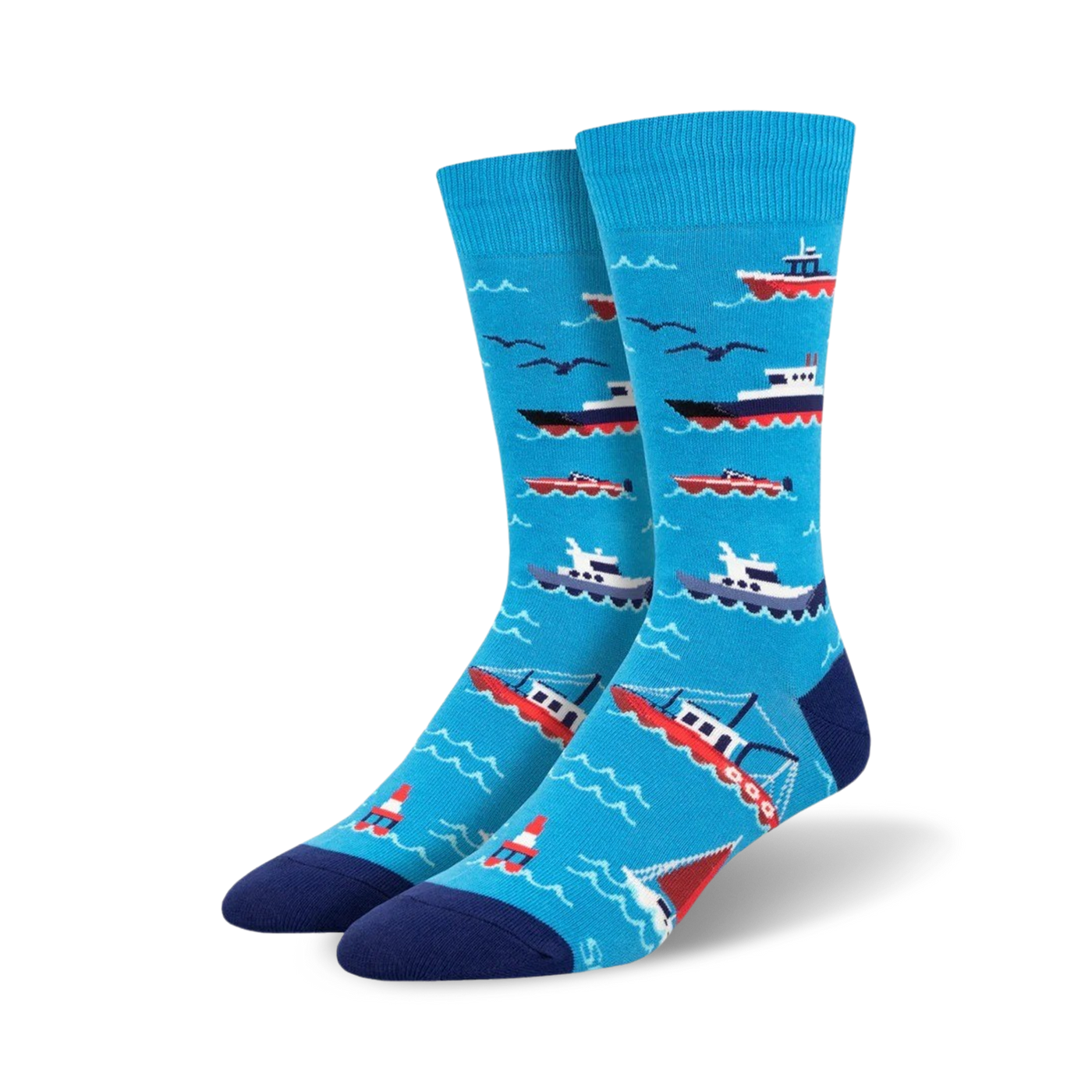 A pair of blue crew socks with illustrated red and white boats, seagulls, and buoys on a wavy ocean pattern. 