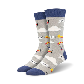 crew length mens socks feature skydivers with parachutes and a cloud and airplane pattern on a light gray background.  
