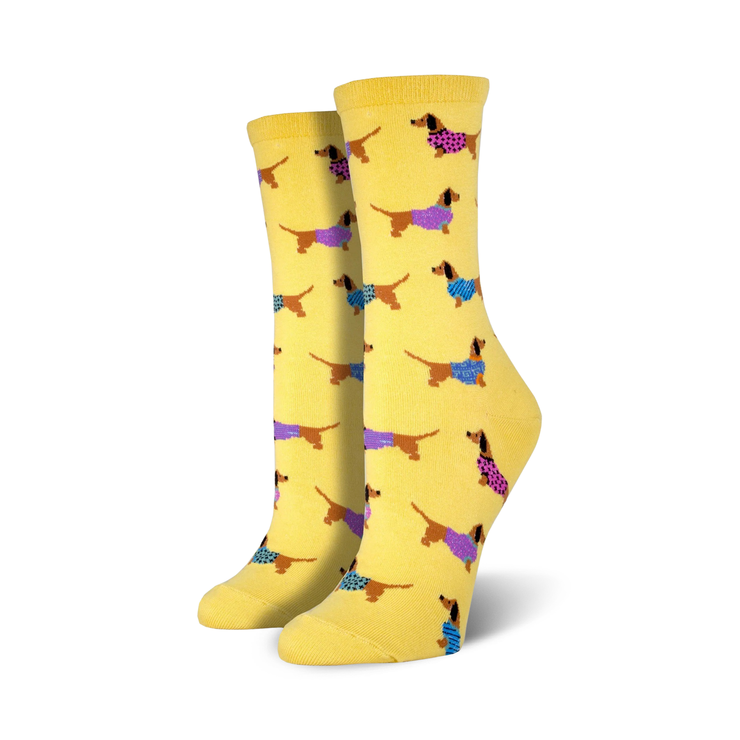 Lifestyle shot of the yellow Haute Dog socks on a model's feet.