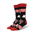 Pair of black crew socks with red and white pig illustrations and tasting notes.  Words like 'yum', 'tasty', and 'good' decorate each pig.