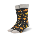 Pair of crew socks with a dark grey background and a whimsical pattern of yellow bananas and pieces of banana bread.