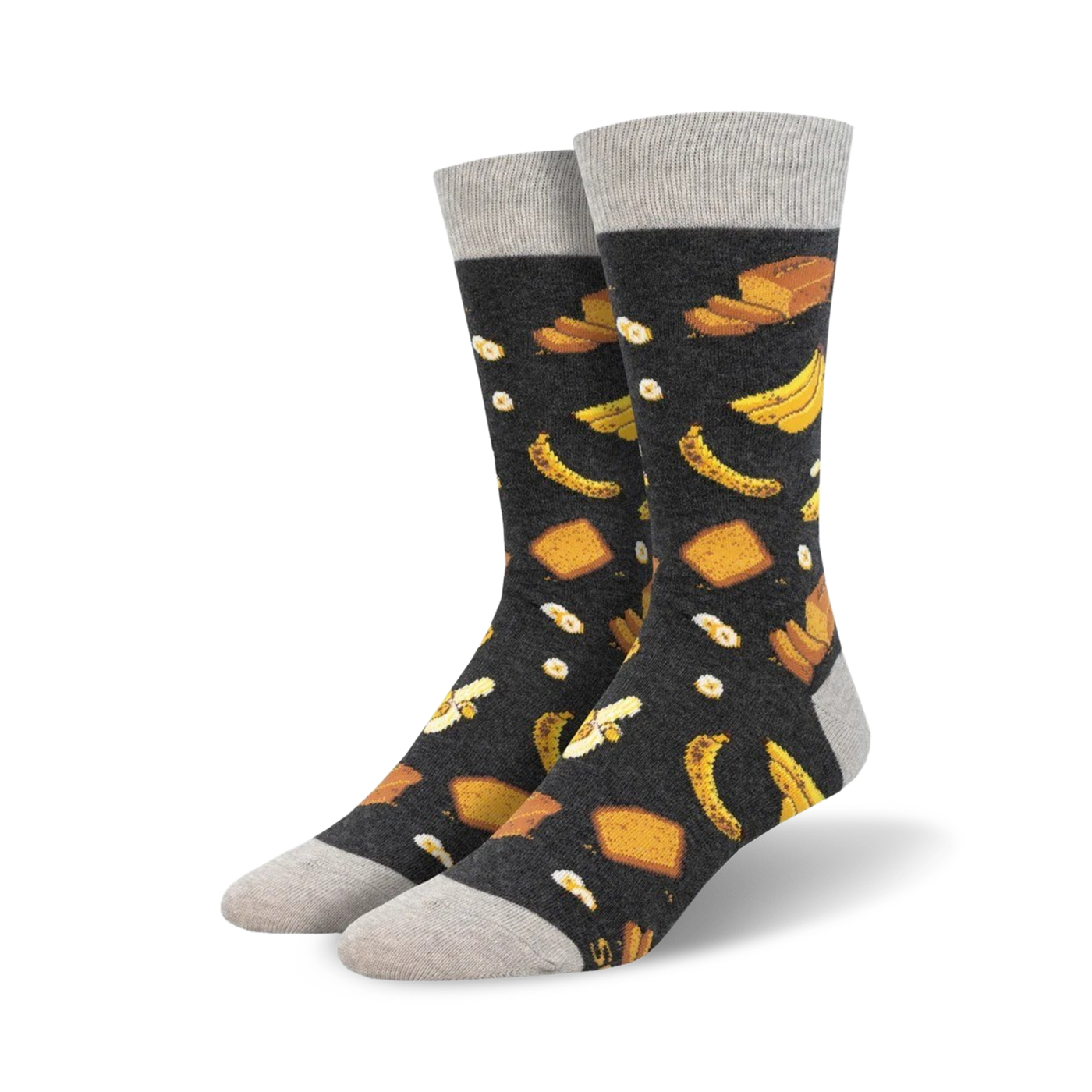 Pair of crew socks with a dark grey background and a whimsical pattern of yellow bananas and pieces of banana bread.