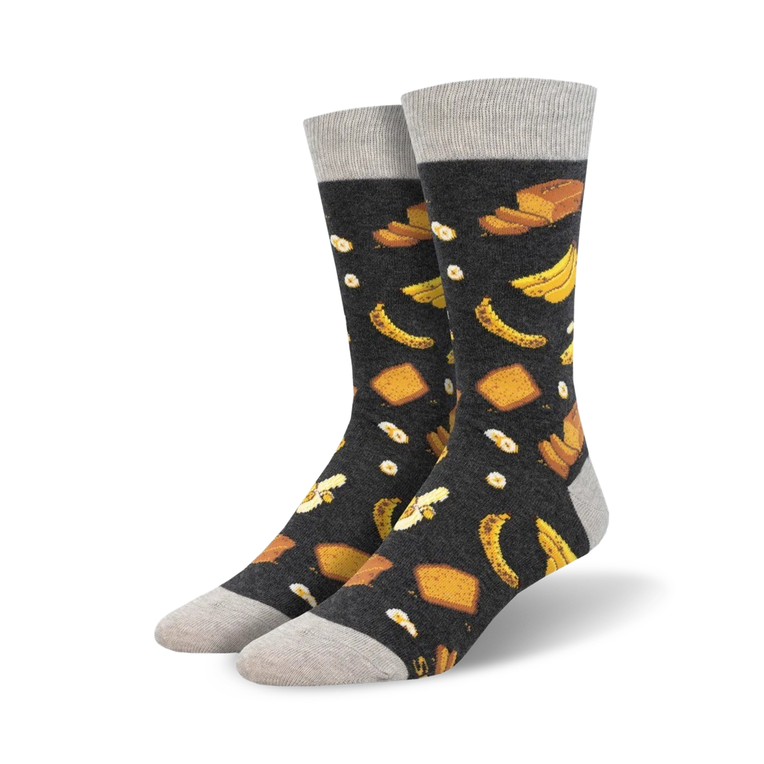 Pair of crew socks with a dark grey background and a whimsical pattern of yellow bananas and pieces of banana bread.