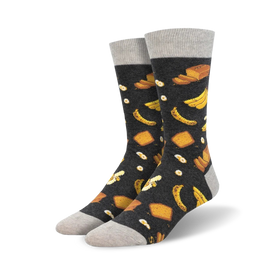 crew length men's socks feature a repeated pattern of bananas, bread slices, and fried eggs on a dark background.   