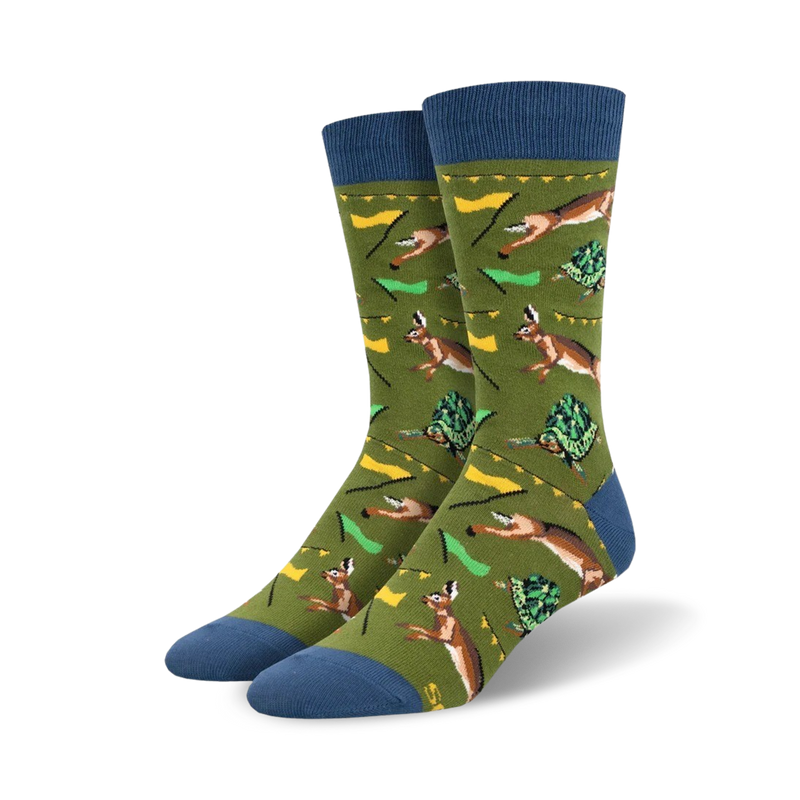 A pair of crew socks in olive green with blue cuffs. The design features a repeating pattern of hares and tortoises in a race, with small flags.