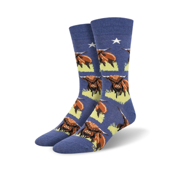 blue crew socks with highland cows on green grass and white stars.   
