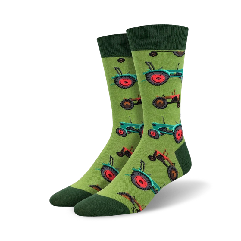 A pair of crew socks on a white background. The socks are lime green with a repeating pattern of teal and red tractors.
