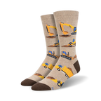 Beige crew socks with repeating illustrations of yellow construction vehicles like bulldozers, excavators, and dump trucks. Brown heel and toe.