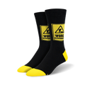 Pair of black crew socks with yellow accents.  A yellow caution sign with 'WORK IN PROGRESS' and a construction worker graphic is featured on each sock.