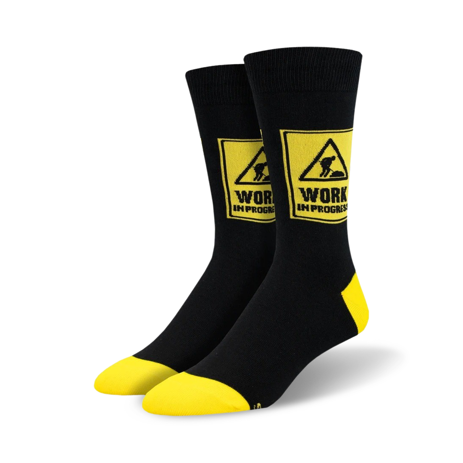Pair of black crew socks with yellow accents.  A yellow caution sign with 'WORK IN PROGRESS' and a construction worker graphic is featured on each sock.