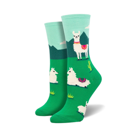 white crew socks with pink and black detailed llamas standing in a green field with cacti and mountains in the background.   