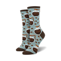 Lifestyle shot of 'Pot Head' socks on a model's feet; light blue socks with brown coffee pot design.