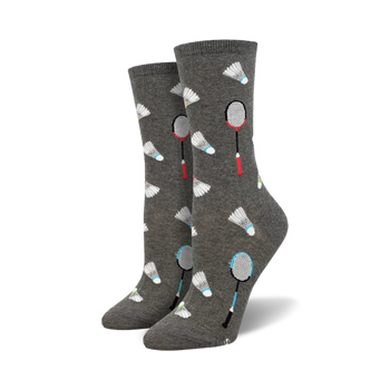 here's a matter-of-fact alt text description:  women's crew socks in gray with a pattern of red, blue, yellow, and white badminton shuttlecocks and blue and red badminton rackets.   