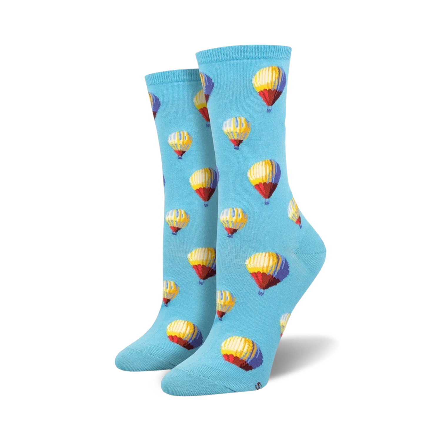A pair of women's crew socks in light blue with a repeating pattern of multicolored hot air balloons.